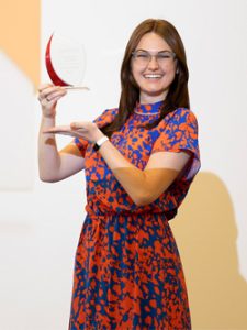 Macayla Mack posing with award