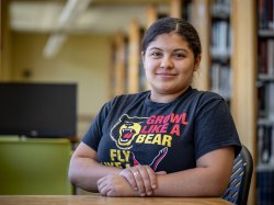 Bloomfield College Nursing student Odyeli Ramos Tobar sits at a table in the campus library, part of the first cohort in the SCHOLAR Certificate program.