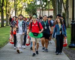 orientation leader walking with a group of students