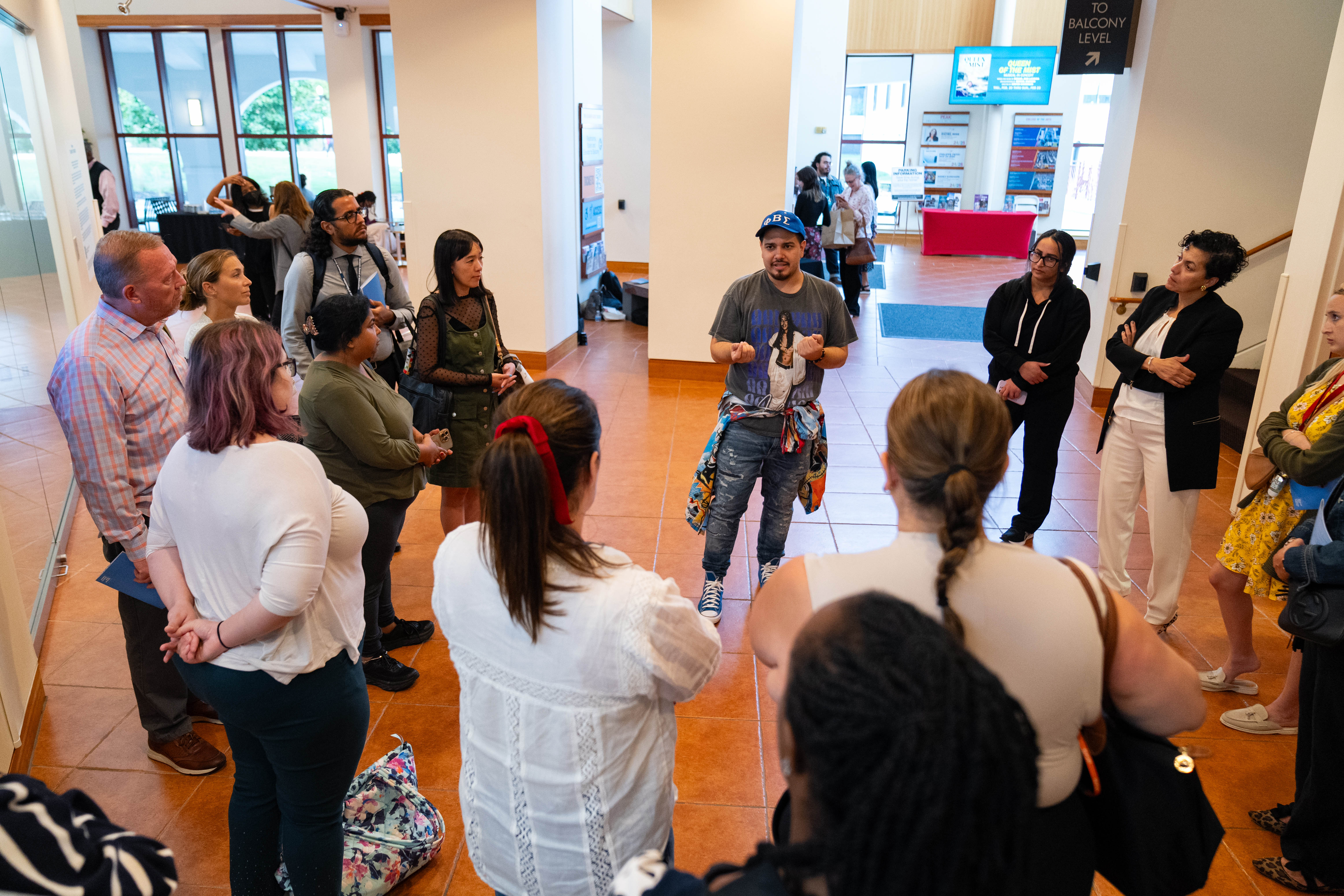 The artist speaks to a class visiting the exhibition in the Kasser theater lobby.