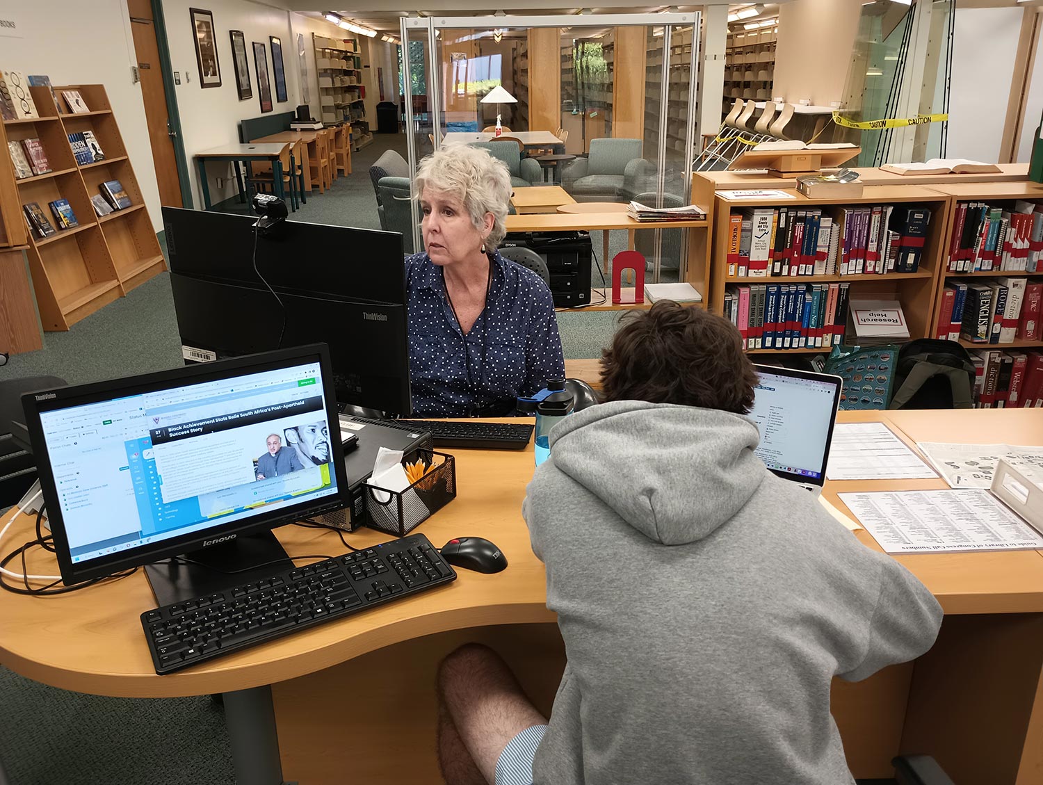Student working with research librarian