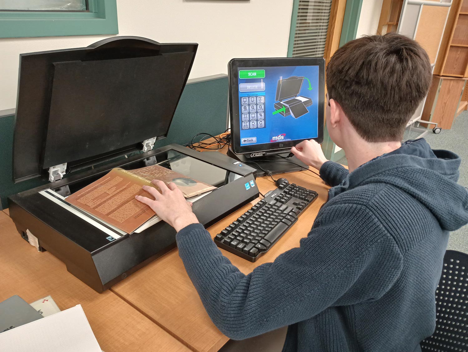 Student using book scanner