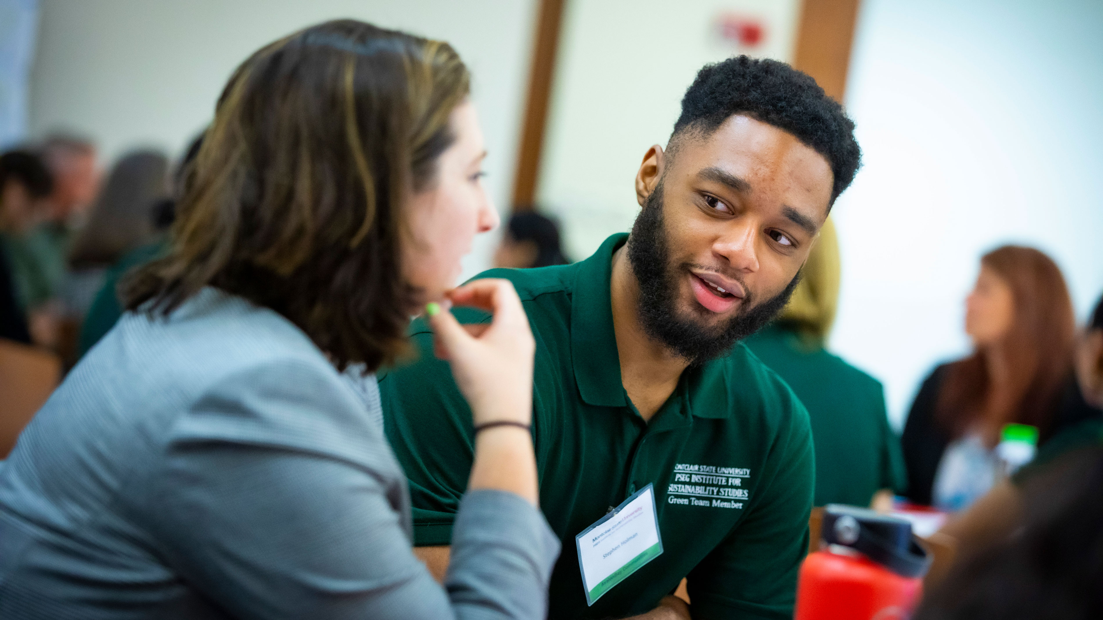 Green Team participants talking at event