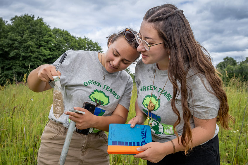 Foodshed Alliance Green Team members looking at soil sample