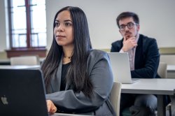 Students in classroom with laptops open on desks