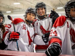 Teammates Sheyla Gomez, left, and Sabrina Robinson are among the Red Hawks inspiring girls to pick up hockey stic