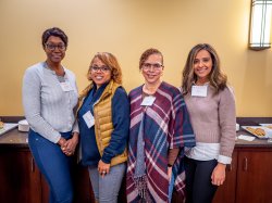 Women pose for a photo at WIN event