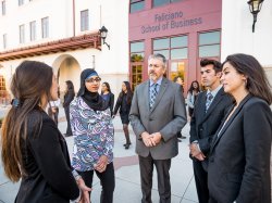 Students and faculty standing outside the Feliciano School of Business