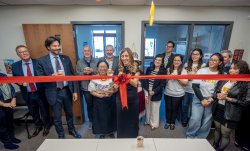 ribbon cutting for CLASE with large group looking on