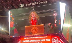 student Paloma Lupino is seen on the jumbotron at Prudential Center for January Commencement Ceremony