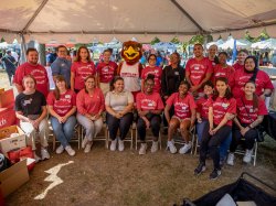 Staff and students from the College for Community Health and the Office of Community Engagement & Partnerships pose for a group picture with Rocky.