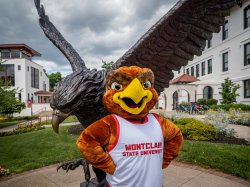 Mascot, Rocky, in front of Red Hawk statue