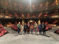 Group of Students and Staff standing on stage in the empty Royal Shakespeare Theater