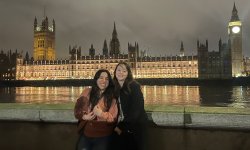students in front of House of Parliament and Big Ben which are lit up at night