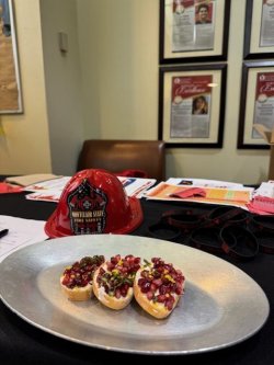 A photo of a fire helmet and food prepared by resident students during a Friends Cooking Safety program at BCSMU.