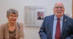 Edward and Valerie Faleski stand in front of a plaque