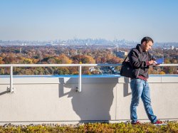 Student at Montclair State in the shadow of the NYc skyline