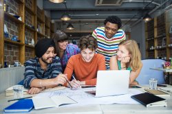 A diverse group of students brainstorming together.