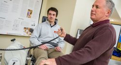 professor and student using equipment in Athletic Training lab