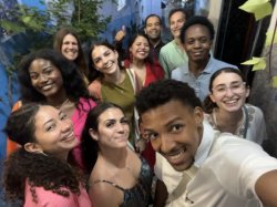 11 happy people in a group selfie