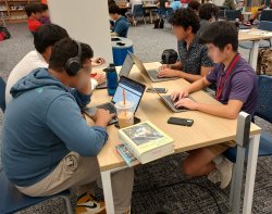 high school students on laptops
