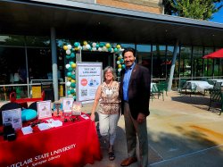 dean mizzy and president koppell at library table