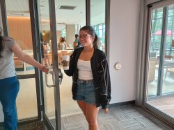 girl entering library from starbucks holding coffee