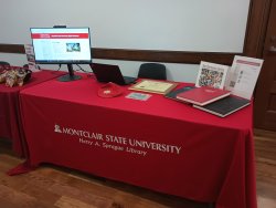 library's table at homecoming with artifacts from the archives