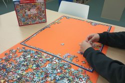 person working on jigsaw puzzle