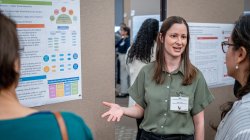 Geena Taite talking with guests during the poster session at the MSU 2024 Student Research Symposium