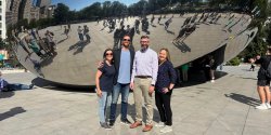 faculty on trip to city, photo in front of art exhibit