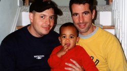 Peter Mercurio and Danny Stewart pose on stairwell with Kevin for family photo