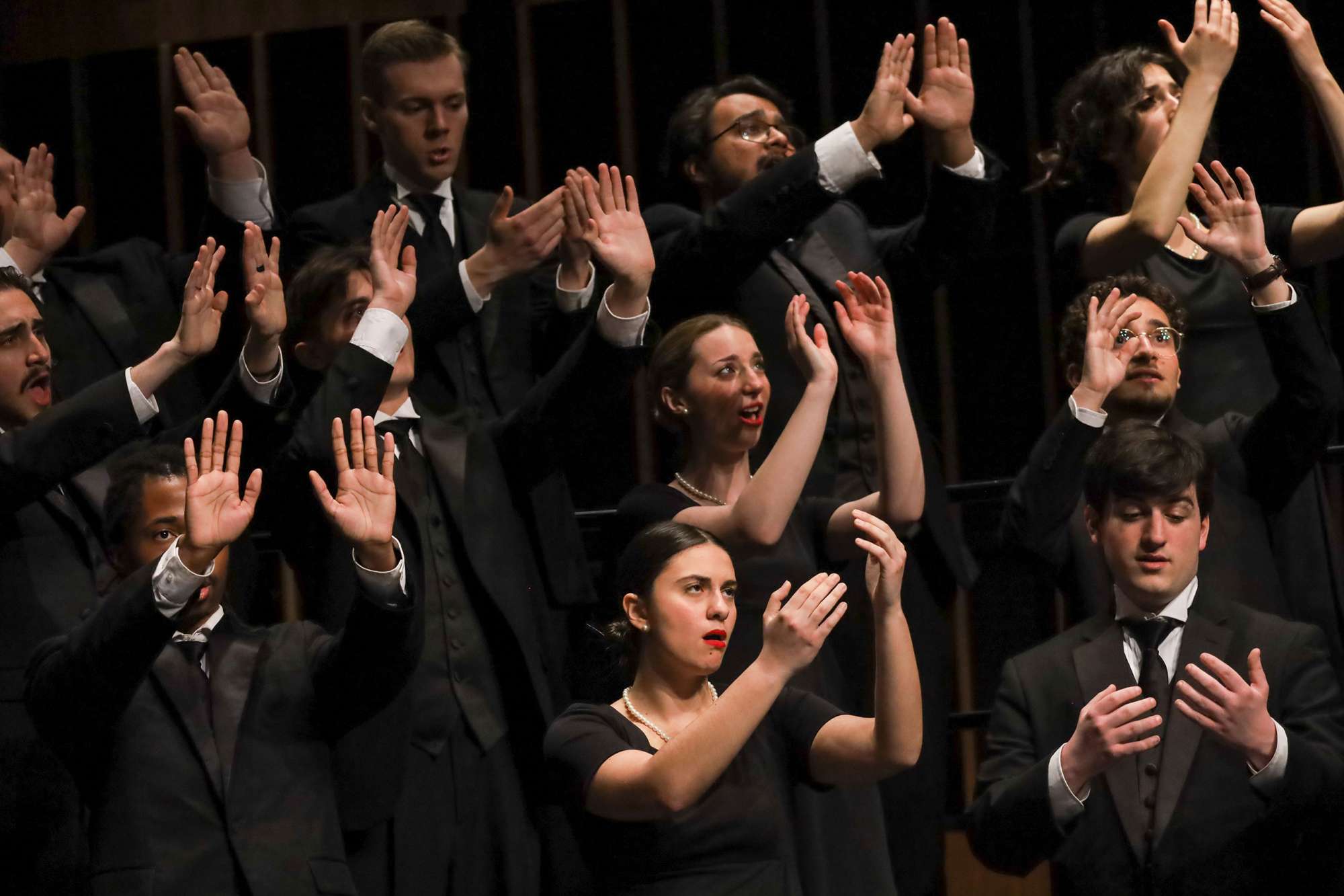 Singers make hand gestures during a song