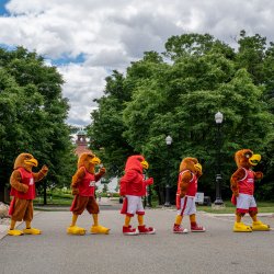 Five students dressed as Rocky walk across campus.