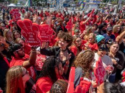 A group of Montclair students, dressed in red, celebrate together during Welcome Week.