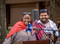 Two students with their country’s flags draped over their shoulders at Montclair State University’s flag-raising event for Hispanic Heritage Month. The student on the left is Pamela Garcia, president of the Latin American Student Association, alongside Marco Cordova, coordinator for Hispanic Serving Initiatives.