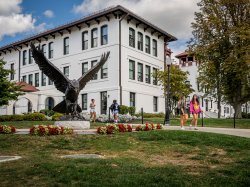 The Red Hawk statue at Montclair State University, set against the backdrop of Spanish Mission Revival architecture. Students often rub the statue's beak for good luck during finals and on game days.