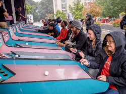 People playing skiball.