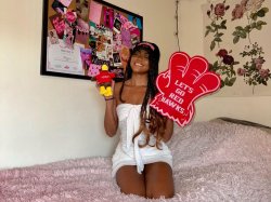 Student sitting on bed in their dorm