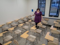 Stephanie Spitz gestures to chairs that are too small for larger students.