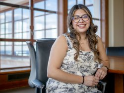 Rebeca A. Soto Avalos sits, leaning against a table.