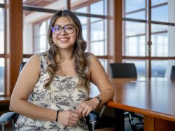 Rebeca A. Soto Avalos sits, leaning against a table.