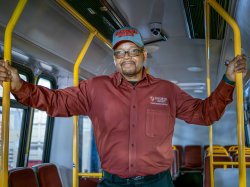 Frank Rivers standing inside shuttle, arms outstretched