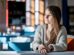 Alex Hatala sitting in a classroom, looking off into the distance