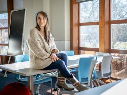 Alex Hatala sitting atop a classroom desk