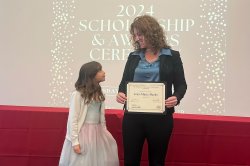 Jean Marie-Beeks holds her award as her daughter Ciara looks at her.