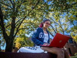 Montclair State University student on laptop.