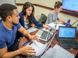 Business students on laptops