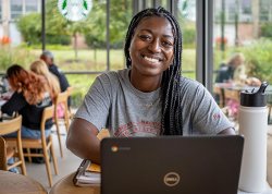 Montclair student studying on laptop at coffee shop