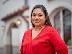 Montclair State University graduate student standing in front of School of Nursing smiling.